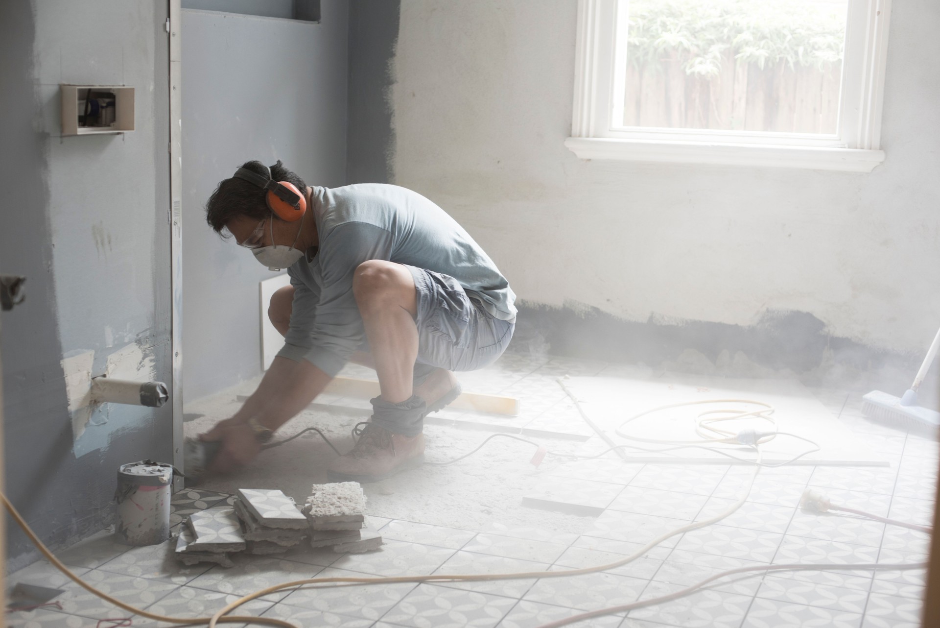Grinding the bathroom floor during a home renovation